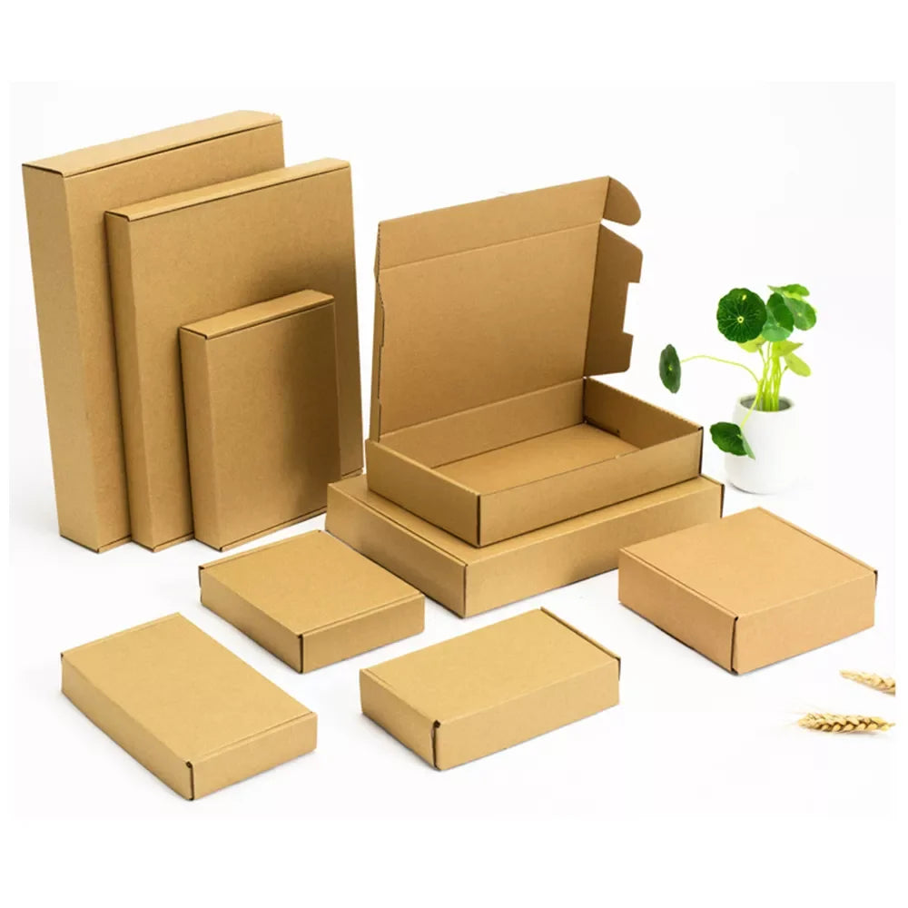 Set of kraft paper shipping boxes and small mailer boxes stacked, open and closed