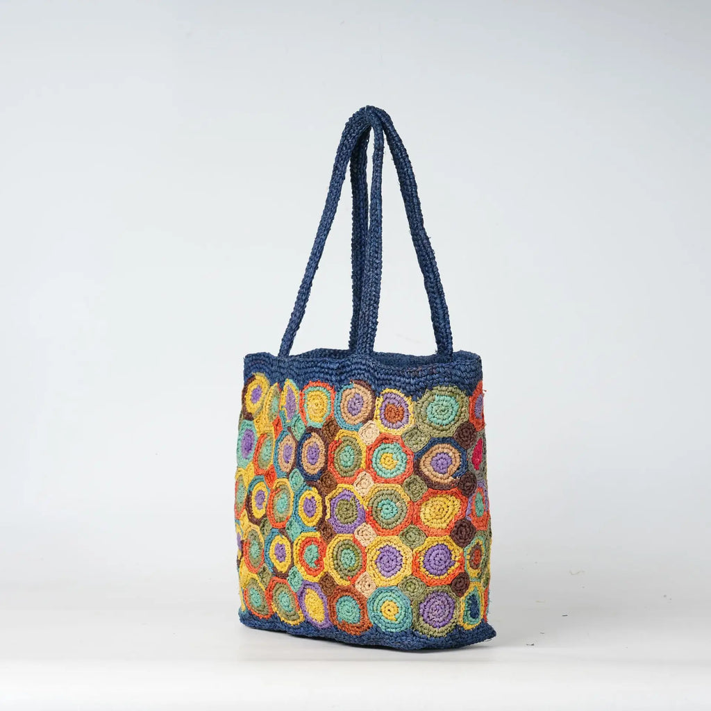 Durable blue woven crochet tote bag with colorful circle patterns, perfect summer beach handbag for women.