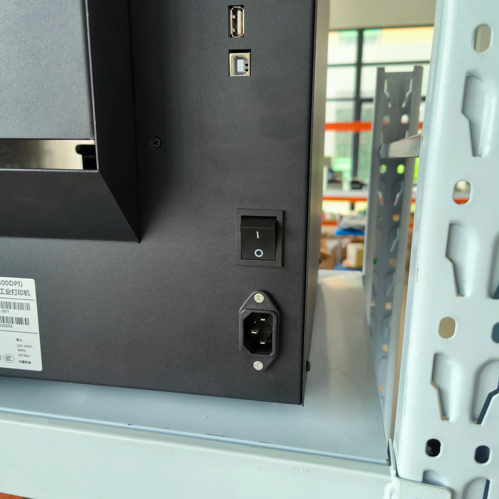Black label printer rear lower area with power socket and ventilation panel