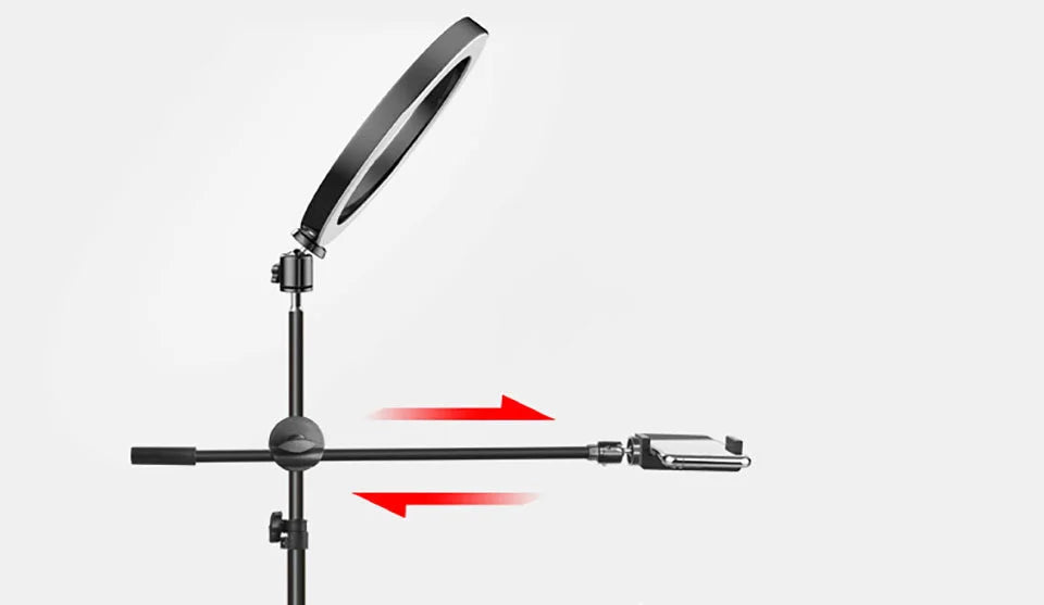 Black ring light on a stand with an adjustable horizontal arm holding a smartphone for content creation.