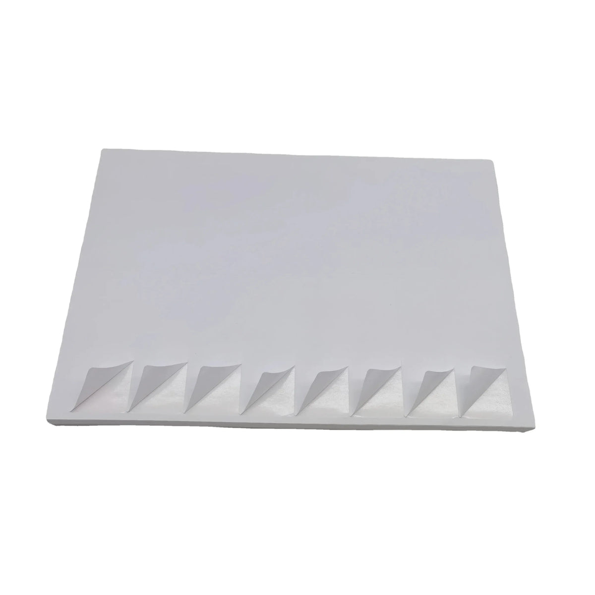 White A4 vinyl sticker sheet with zigzag cut backing, stacked