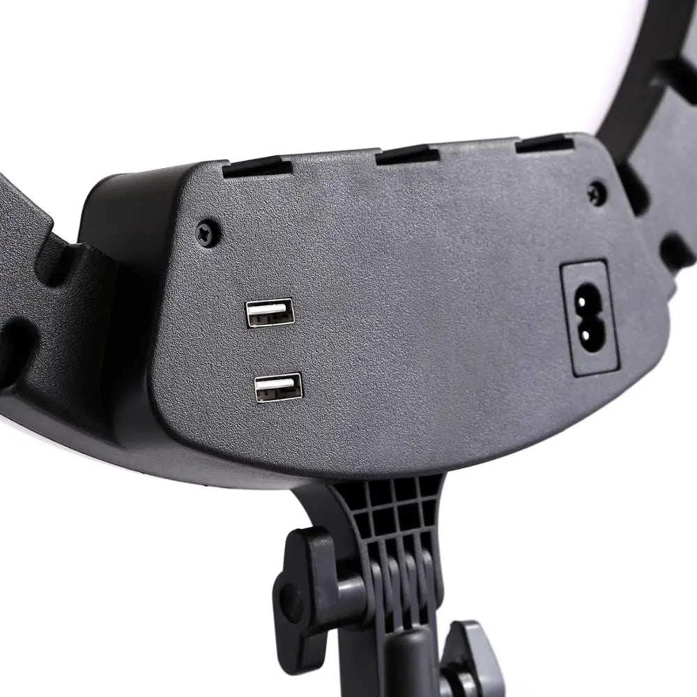 Black plastic ring light housing with two USB charging ports and a power input, mounted on an adjustable stand.