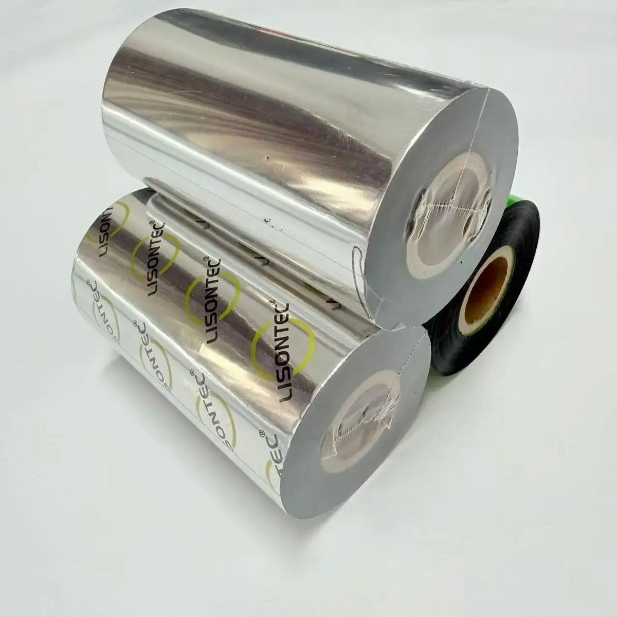 Two wax thermal transfer ribbon rolls, silver backing with black tape on cores