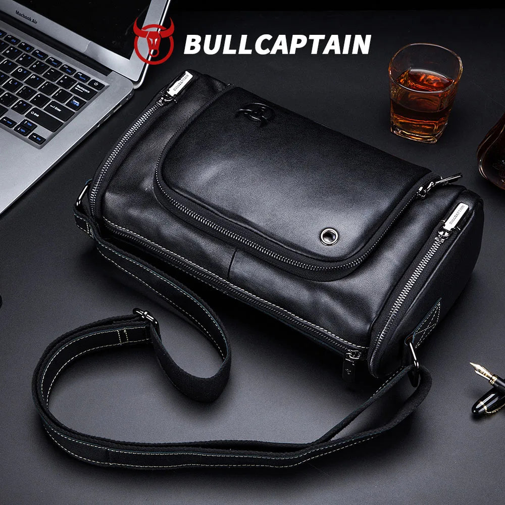 BULLCAPTAIN black cowhide leather messenger trunk bag with zip compartments and adjustable crossbody shoulder strap.