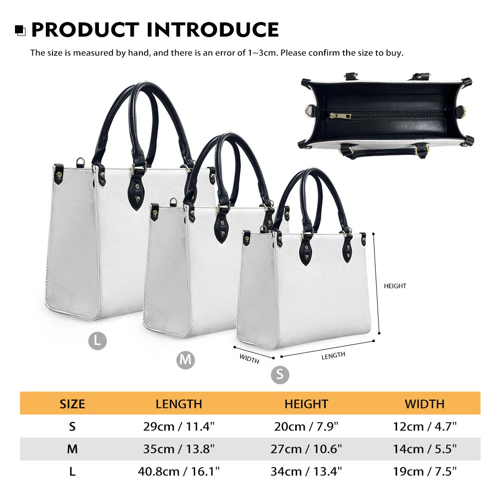 Three sizes of white textured leather trunk handbags with black handles and floral tribal patterns, featuring top zips.