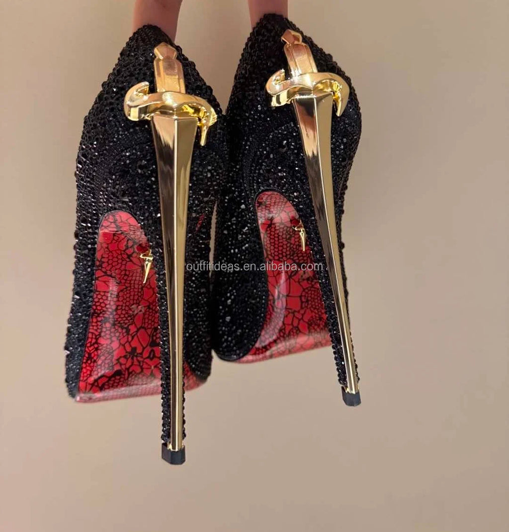 Black crystal-embellished luxury evening pumps with gold sword-shaped stiletto heels and red lace-print soles.