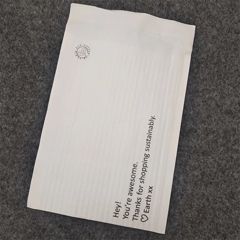 White padded shipping mailer bag with small icon and vertical sustainability message
