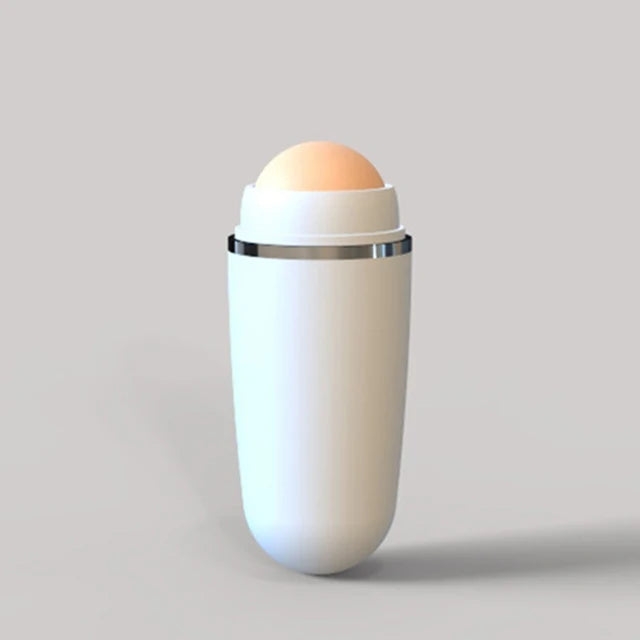 White facial oil-absorbing roller with a round, tan volcanic stone top, featuring a sleek, minimalist design.