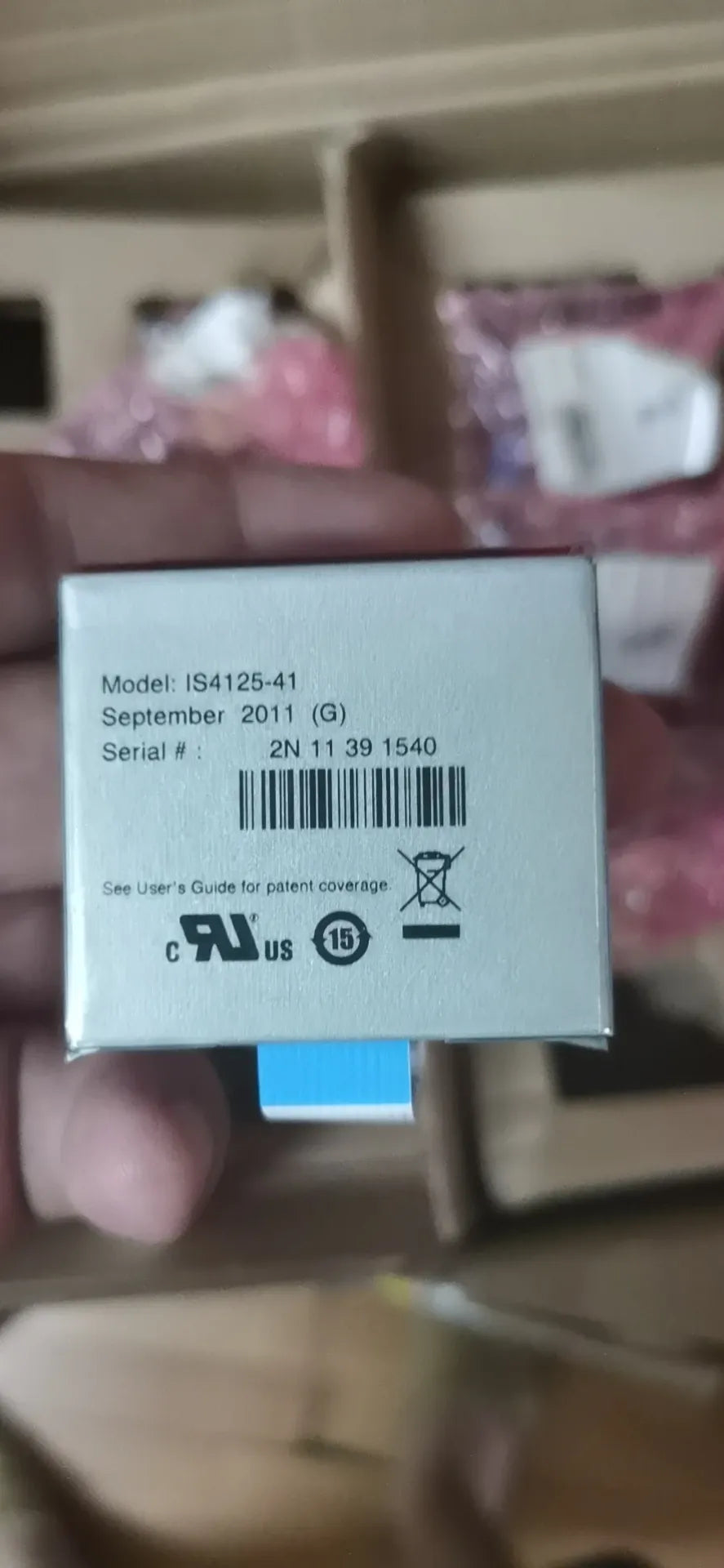 Barcode scanner module held in hand with model label and blue connector