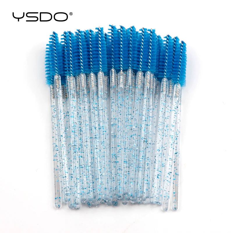Disposable eyelash brushes with bright blue heads and clear, blue-glitter plastic handles for lash and brow grooming.