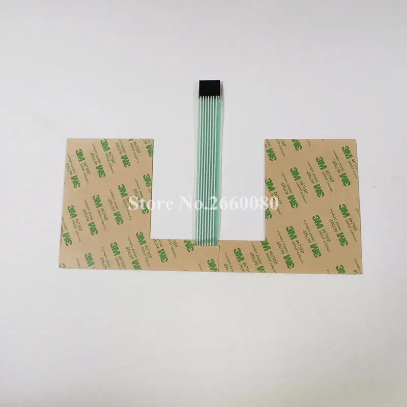 Keyboard film backer sheet with green ribbon cable, printed text backing on both sides
