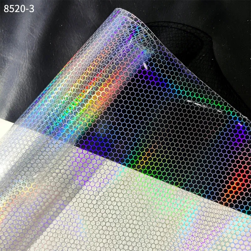 Transparent PVC film sheet with holographic snake-skin scale pattern and rainbow highlights.