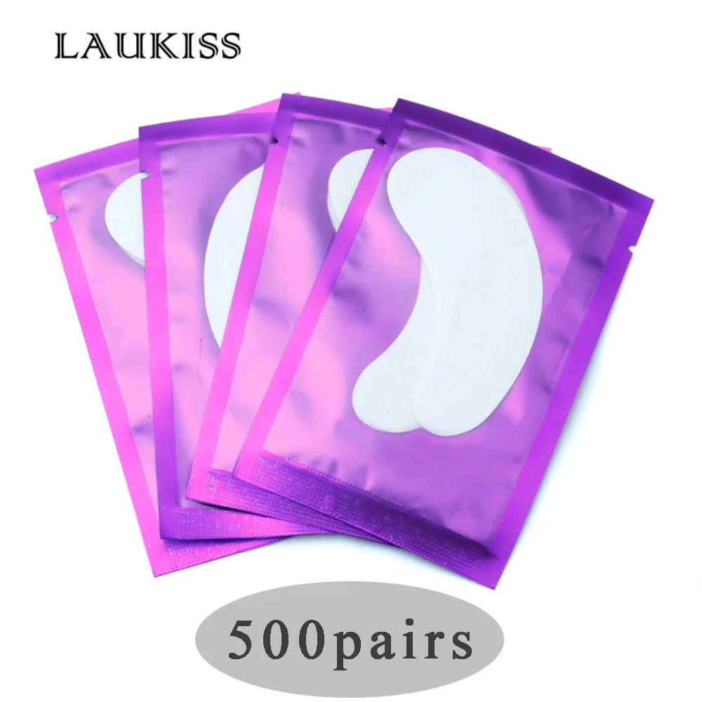 White gel eyelash extension pads in shiny purple foil sachets for professional lash application.