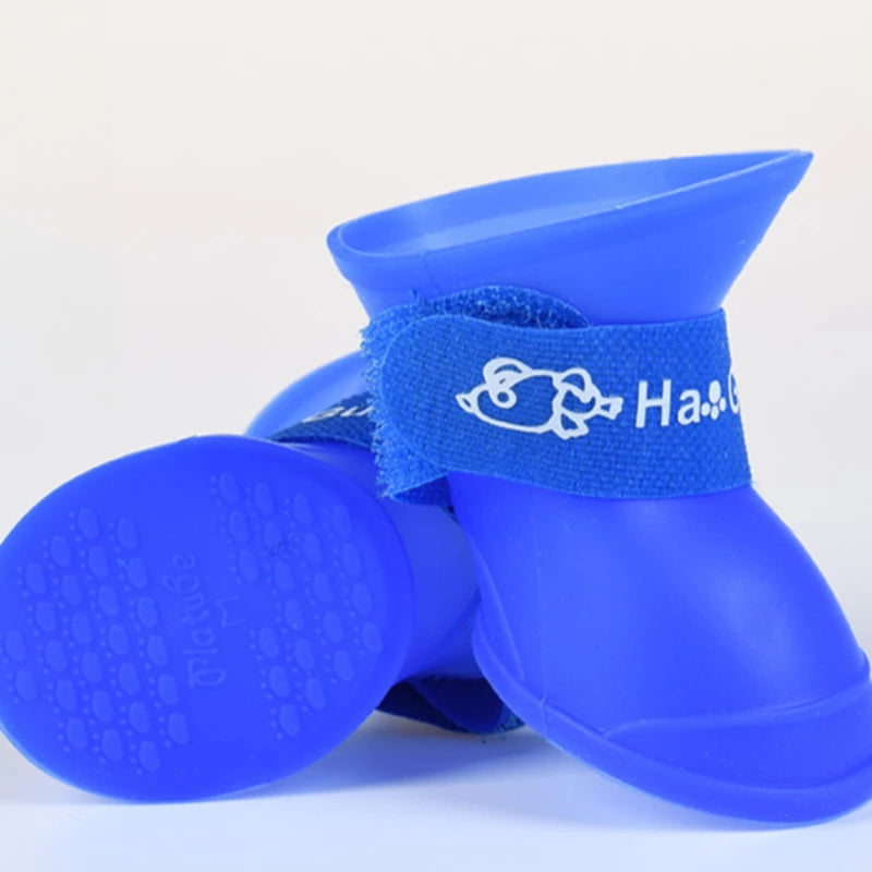Blue waterproof non-slip dog rain boots with secure velcro straps for dry, protected paws during outdoor walks.