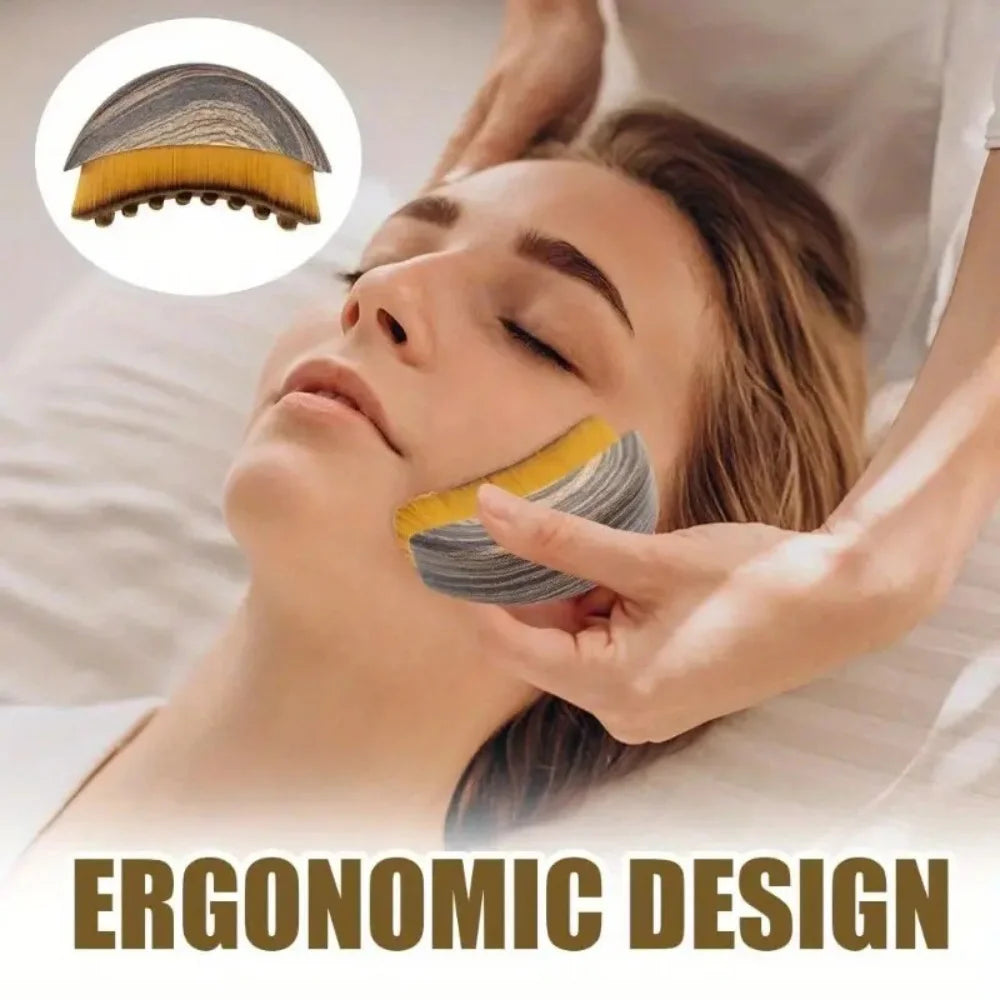 Ergonomic, curved wooden-finish face brush with yellow bristles being used to massage a woman’s jawline.