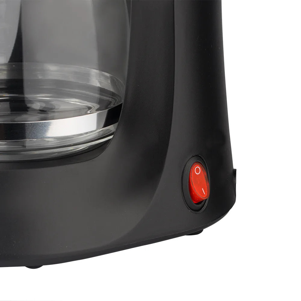 Black plastic drip coffee maker with glass carafe and red power switch on base.