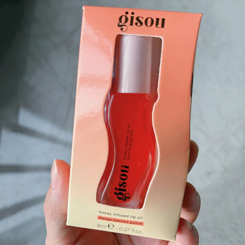 Gisou Honey Infused Lip Oil in Mango Passion Punch, a hydrating, glossy red lip treatment in its original packaging.