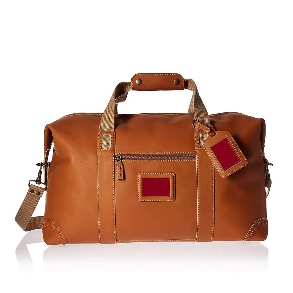 Tan PU leather travel trunk duffel bag with crossbody strap, top handles, and side luggage tag, perfect for travel.