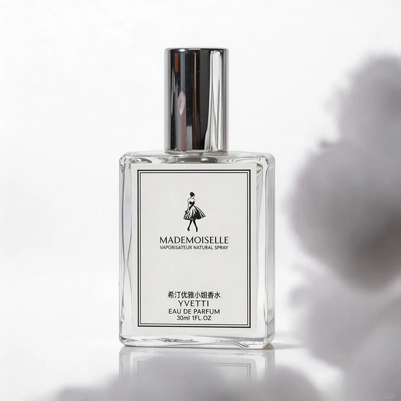 Yvetti Mademoiselle EDP: Floral-fruity women's perfume in a sleek rectangular glass bottle with silver cap.