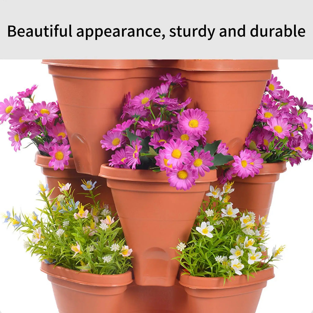 Orange plastic vertical planter tower with multi-tier pots filled with purple and green plants