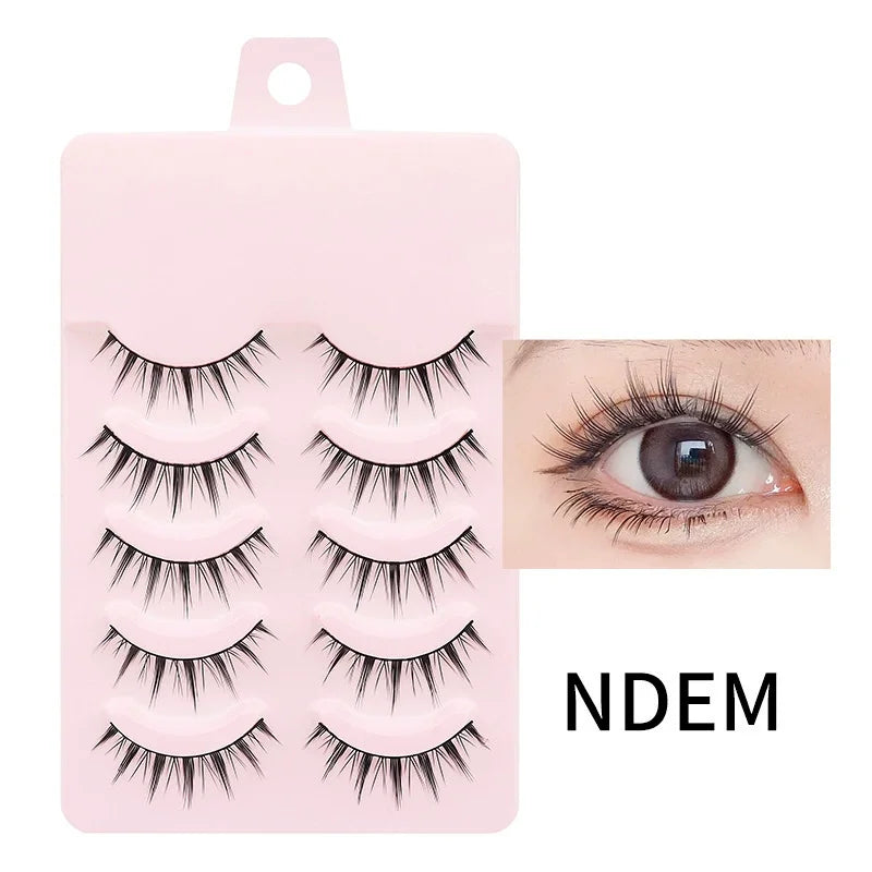 Five pairs of natural, wispy black false eyelashes on a pink tray, shown applied to an eyelid.
