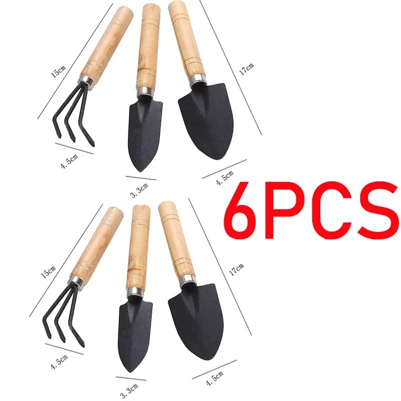 Mini garden tool set with wooden handles and black hand cultivator and spade heads
