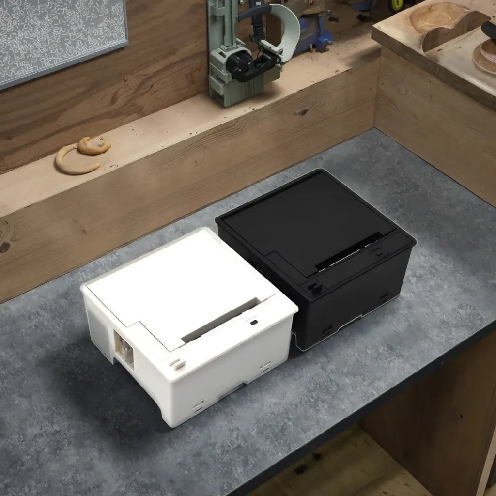 Embedded thermal label printer module with black and white cases on workbench
