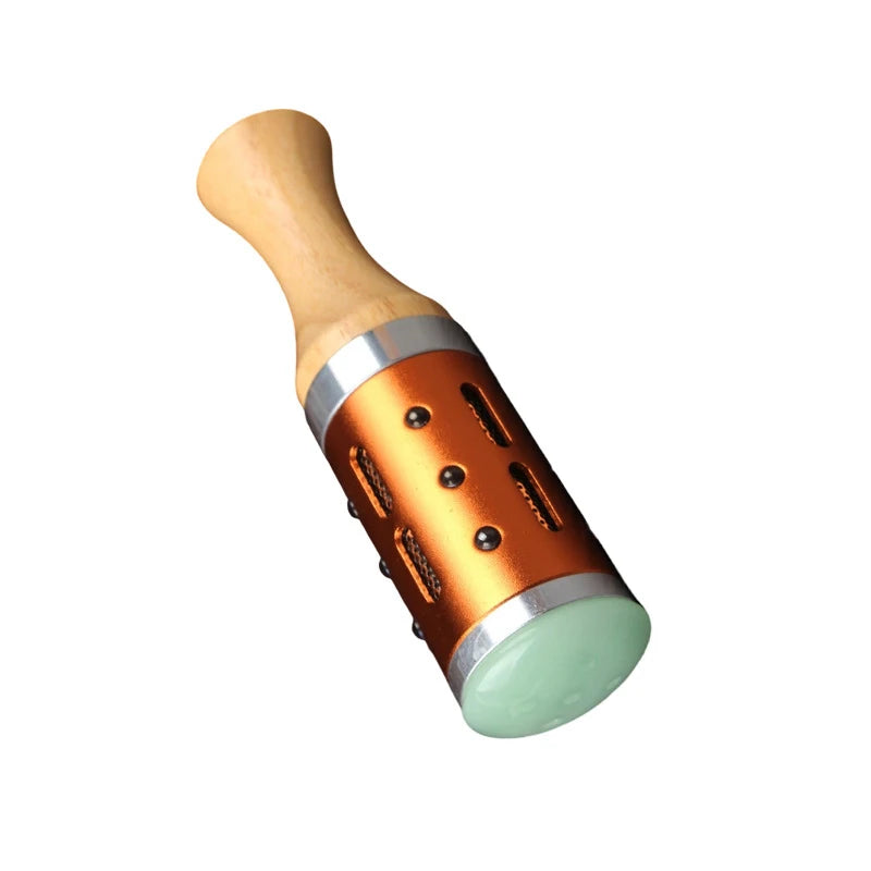 Warm jade facial massage device with wooden handle and orange metal casing for hot compress moxibustion therapy.