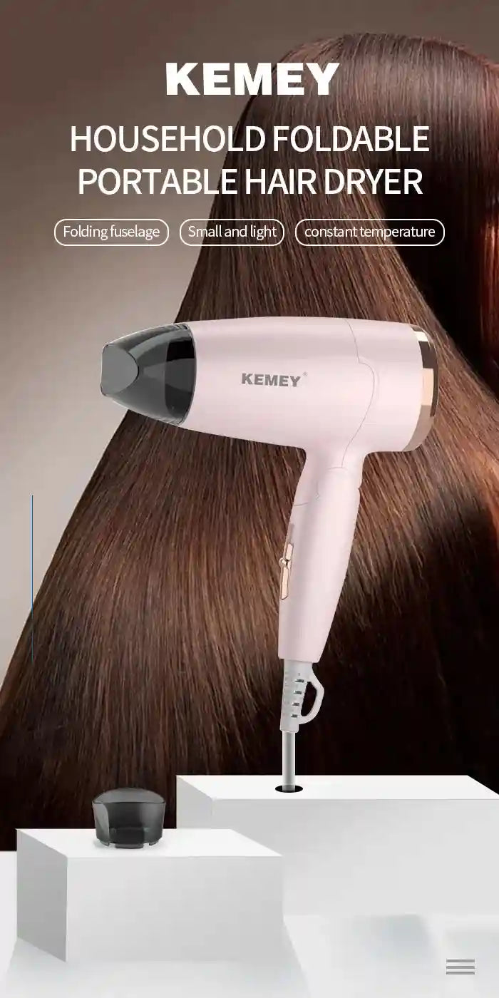 Pink Kemei foldable travel hair dryer with concentrator nozzle, compact 950W design for efficient hair styling.