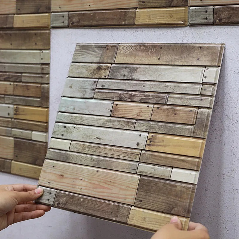 Peel-and-stick backsplash tile sheet with faux wood plank pattern in light and medium wood tones