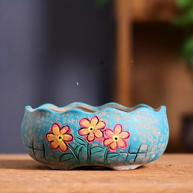 Turquoise ceramic oval planter with hand-painted daisy cluster in pink and yellow centers