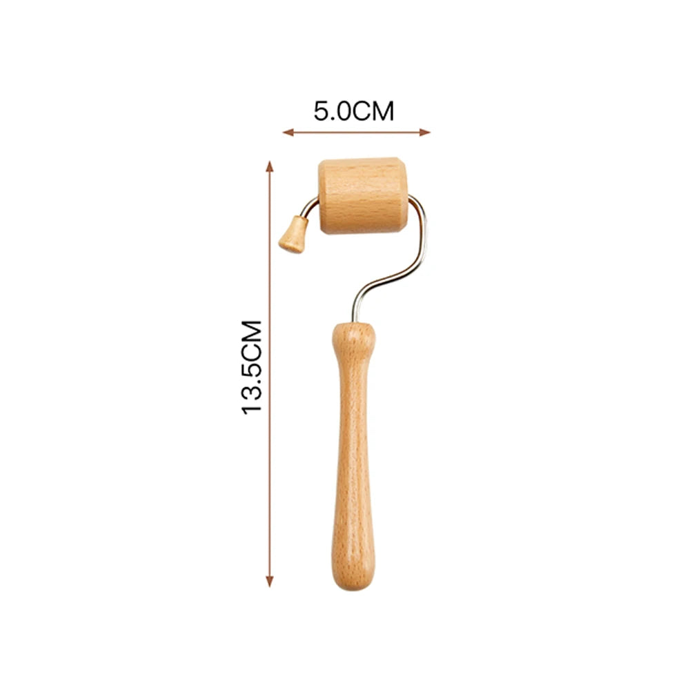 Light wood face massage roller with a metal frame and handle, measuring 5cm wide and 13.5cm tall.