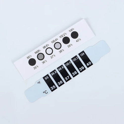 White and black baby forehead strip thermometer for quick baby health temperature monitoring.