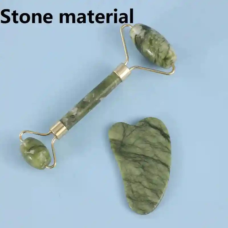 Green marble-patterned facial roller and heart-shaped gua sha stone set with gold-tone metal accents.