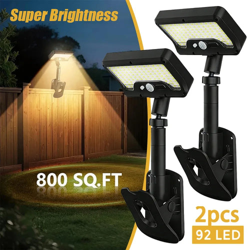 Two black solar LED motion sensor lights with adjustable arms and mounting clips for outdoor use.