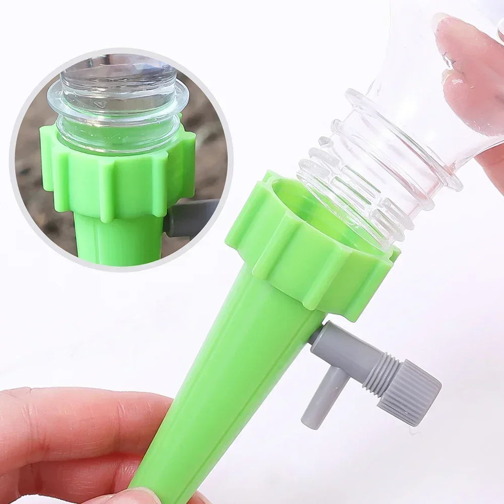 Green drip irrigation stake with clear bottle top and adjustable gray regulator