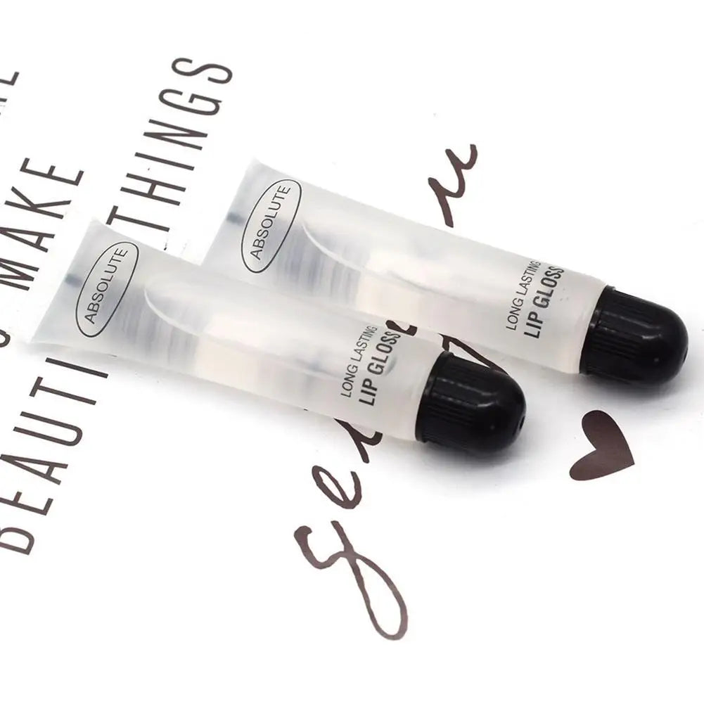 Two transparent, long-lasting Absolute moisturizing lip gloss tubes with black caps on a decorative white background.