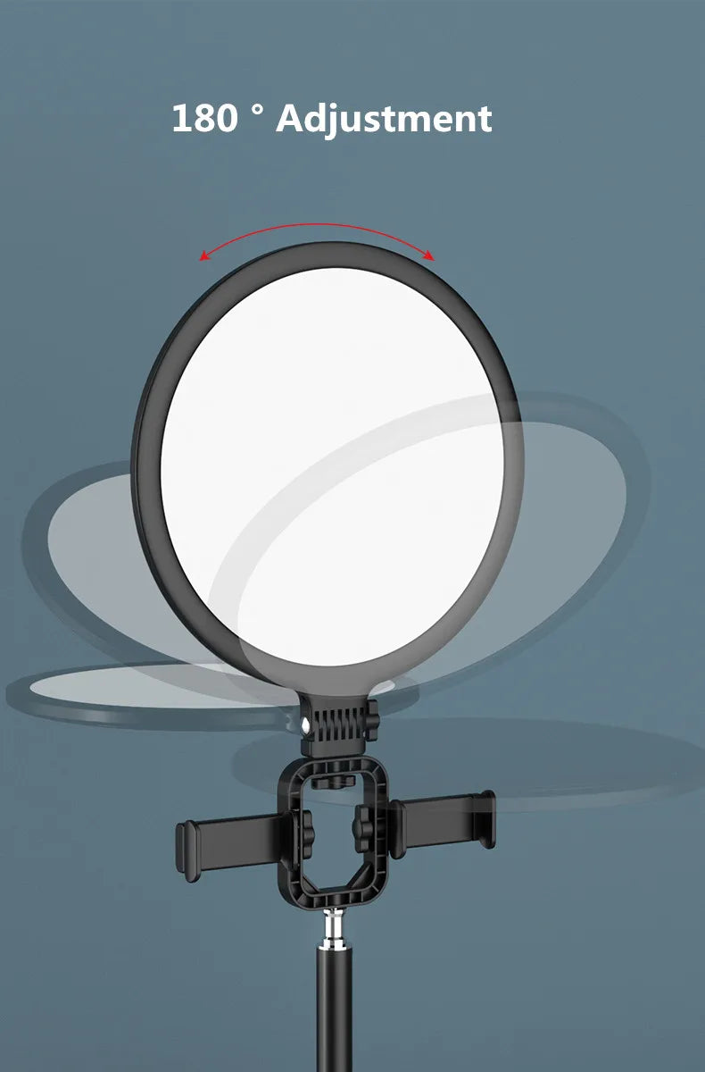 Black circular LED ring light with a 180-degree adjustable tilt mount and integrated phone holder for photography.