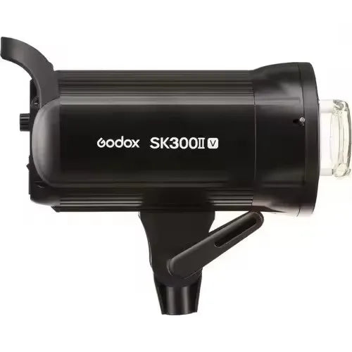 Black cylindrical studio strobe flash with integrated mounting bracket and glass lens for professional photography.