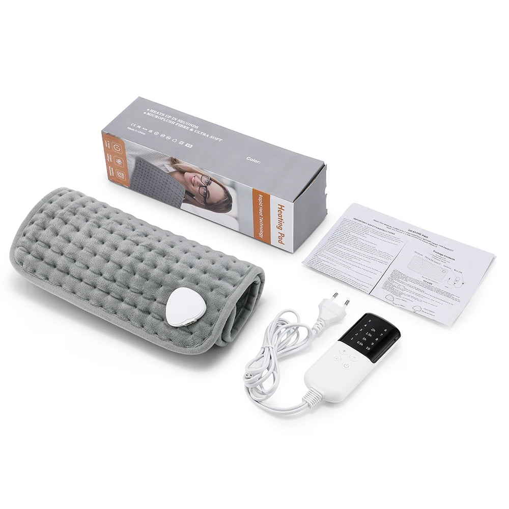 Grey, quilted rectangular heating pad with white digital remote control, packaging box, and instruction manual.