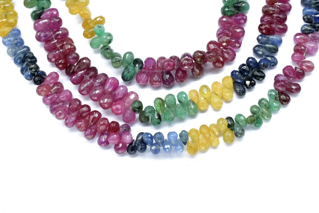 Multi-color faceted drop bead strands (4x6mm) laid in a layered arrangement