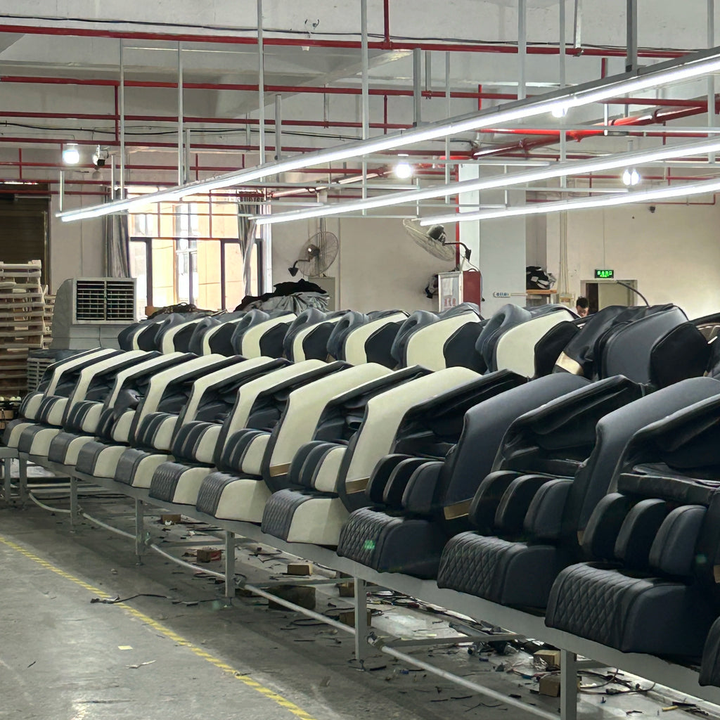 Gray massage chairs with segmented back rollers and armrests, arranged in a row