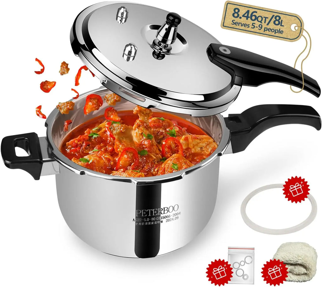 Stainless steel pressure cooker with lid open showing chunky red stew