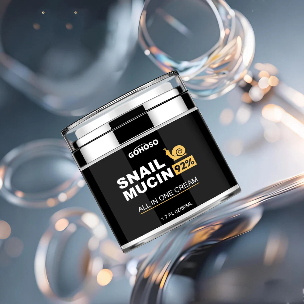 Black 50ml jar of Snail Mucin 92% all-in-one face cream with a silver lid, set against a blurred reflective background.