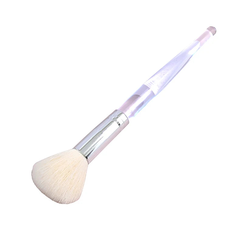 Soft facial cleansing and mask brush with fluffy bristles and a clear acrylic handle for portable skin care.