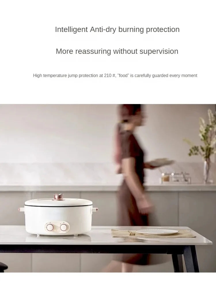 White electric hot pot with lid on countertop and two front control knobs
