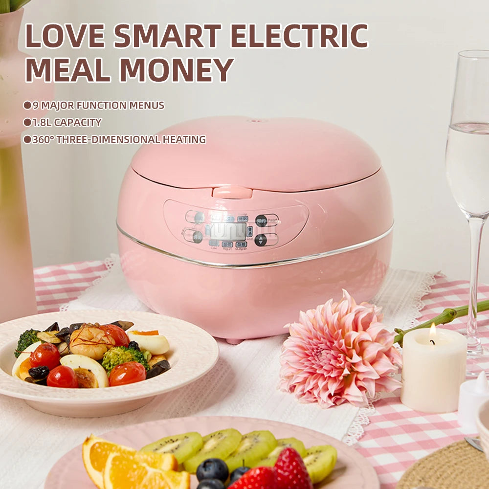 Pink heart-shaped electric rice cooker with closed lid and lit-up control panel area.