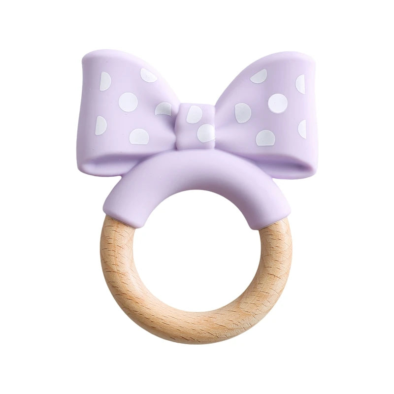 Lavender silicone and natural wood bow baby teething ring for teething relief.