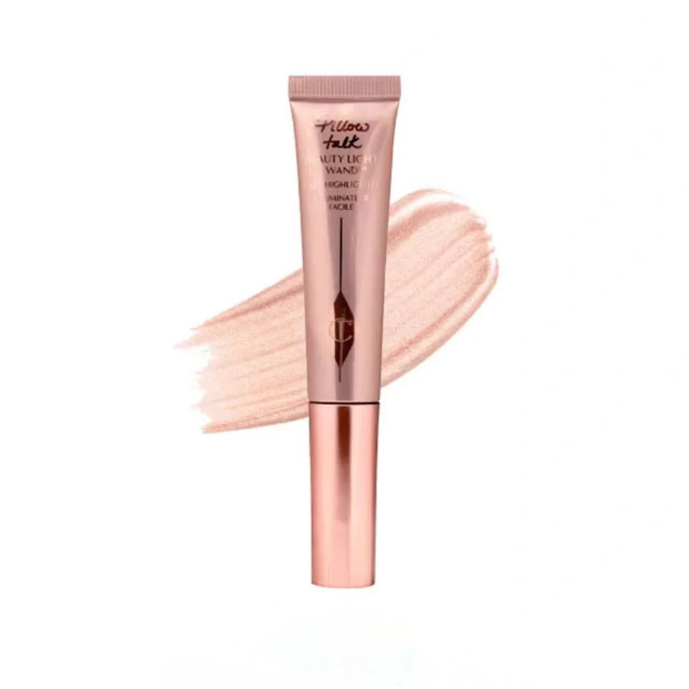 Charlotte Tilbury Pillow Talk Beauty Light Wand in shimmery rose gold with a creamy, luminous liquid texture swatch.