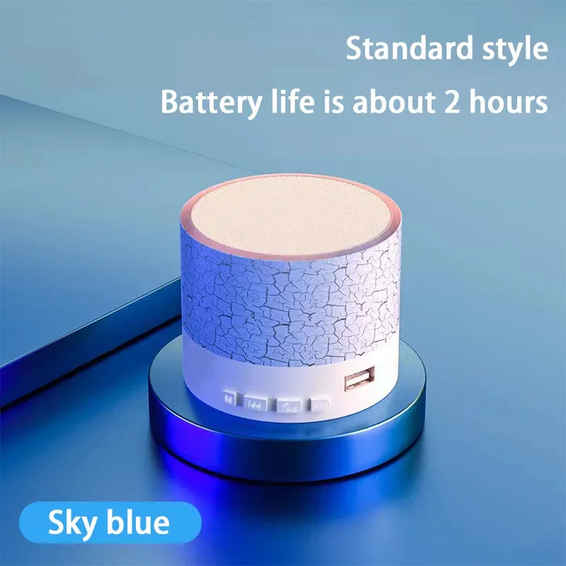 Portable Bluetooth speaker with sky blue textured body and beige top panel